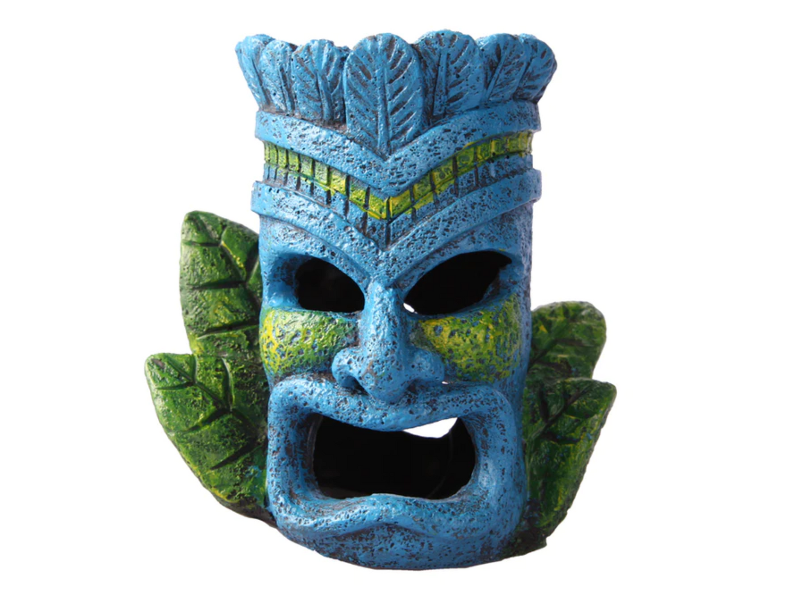A vibrant blue tiki head figurine features intricate designs and a textured finish, accented with green and yellow details. It is surrounded by green foliage, adding a tropical touch ideal for terrariums or aquariums.
