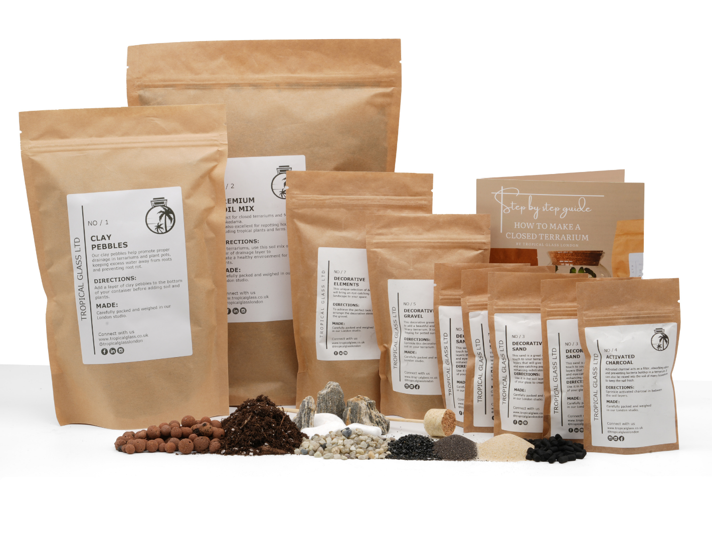 A variety of terrarium supplies is displayed, including bags labeled with ingredients such as clay pebbles, premium soil mix, and decorative elements.