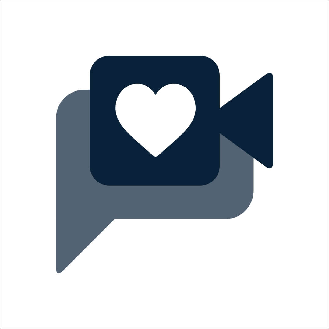 A dark blue video camera icon featuring a heart symbol inside, set against a light background. The camera is positioned within a speech bubble shape, emphasizing a personal and heartfelt message concept.