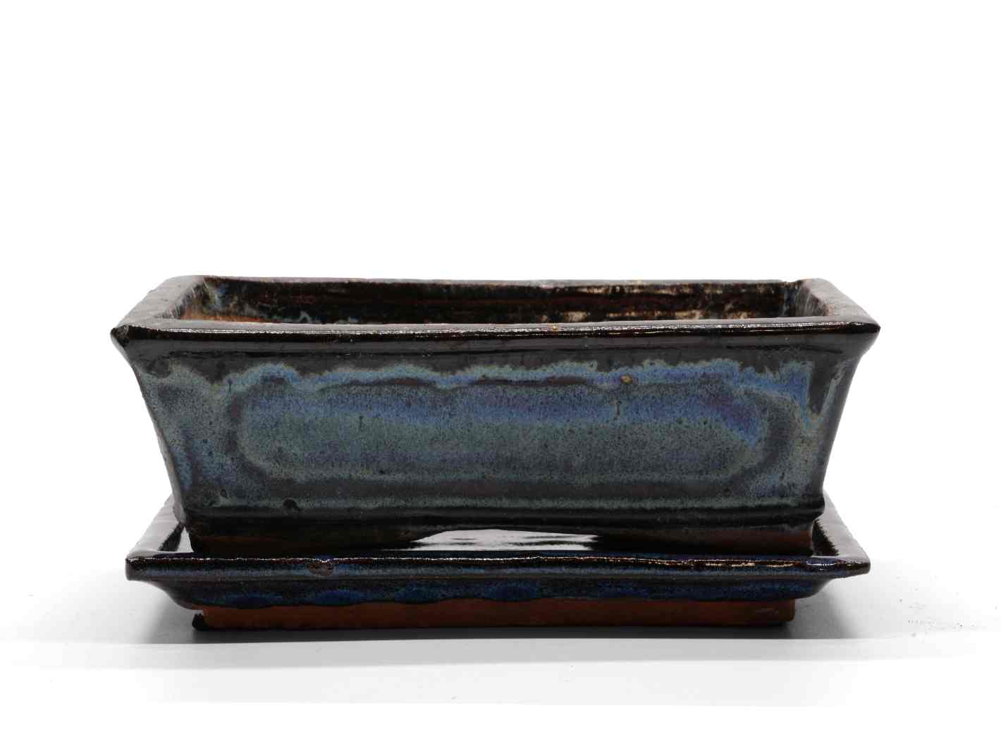 A rectangular decorative pot with a saucer, featuring a glossy dark blue finish with subtle variations in color. The pot has a sleek, modern design.