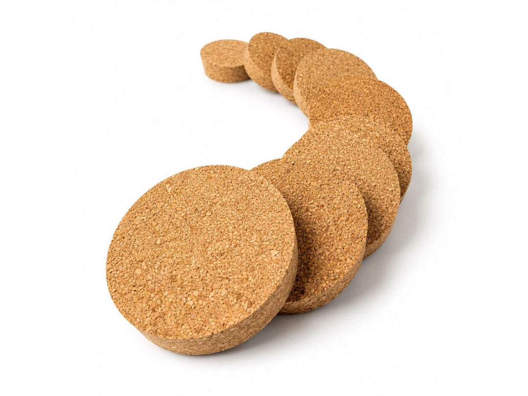 A set of round cork coasters in various sizes, arranged in a curved row on a plain white background.