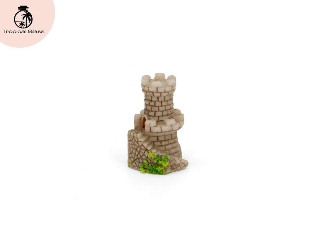 Mini mossy fairy castle figurine decorating a tiny woodland style terrarium scene