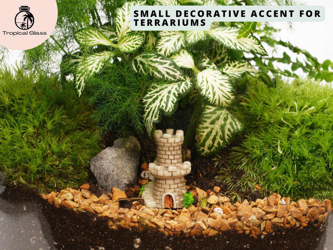 Mini fairy castle figurine in a fairy garden style display with moss and gravel