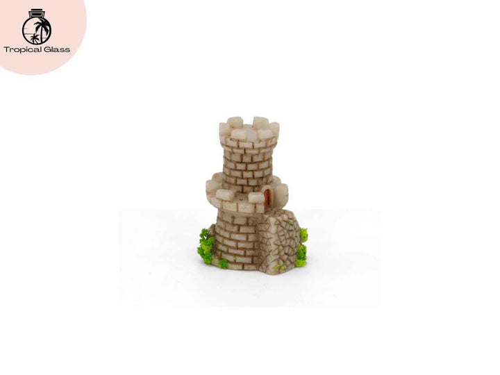 Side profile view of the mini mossy fairy castle figurine with tower and arched door detail