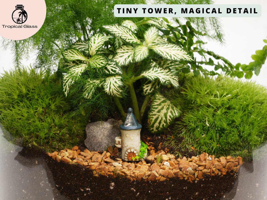 Mini fairy castle tower figurine in a fairy garden style display with moss and stones