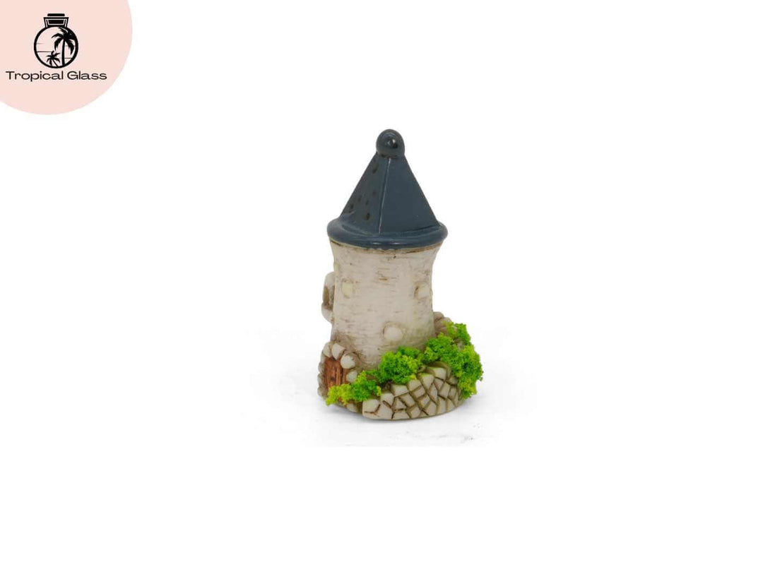 Side profile view of the mini fairy castle tower figurine with pointed roof and stone detail