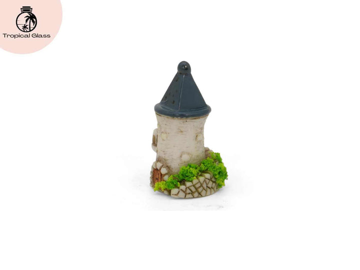 Side profile view of the mini fairy castle tower figurine with pointed roof and stone detail