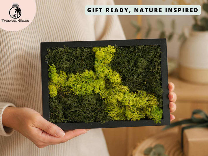Handmade preserved moss frame held in hands, showing the compact 17 x 24 cm size and natural moss texture
