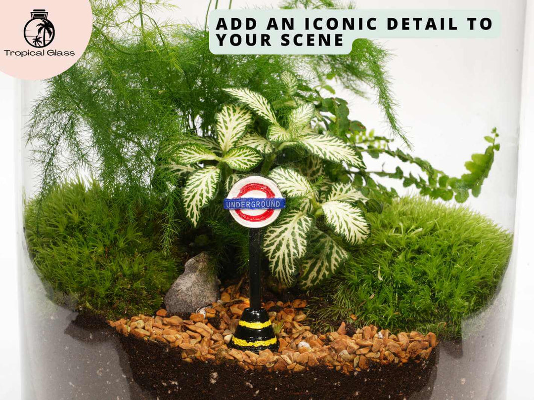London Tube sign miniature placed inside a terrarium with plants and moss