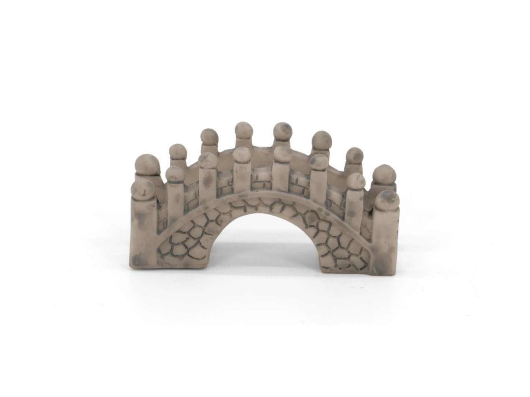 Mini bridge figurine in grey stone effect on white background, terrarium decoration