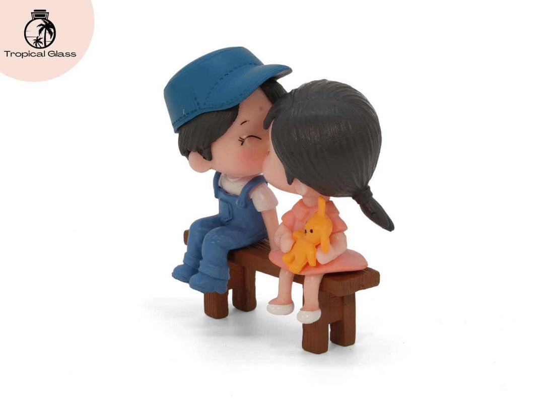 Mini couple figurine sitting on bench, side view, miniature scene detail