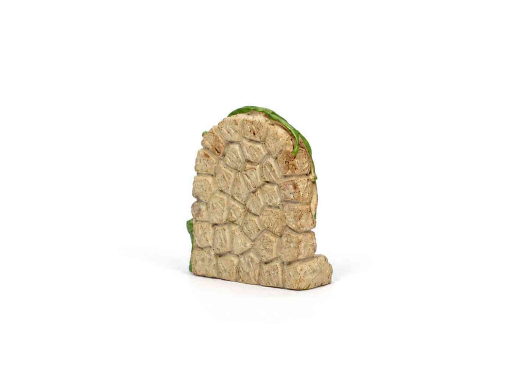 Miniature fairy door in a terrarium with moss, pebbles, and plants
