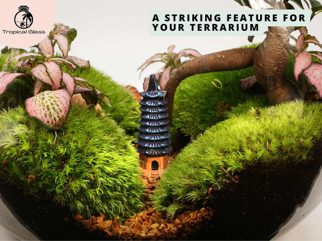 Mini pagoda tower ornament placed inside terrarium, miniature scene with plants and natural elements