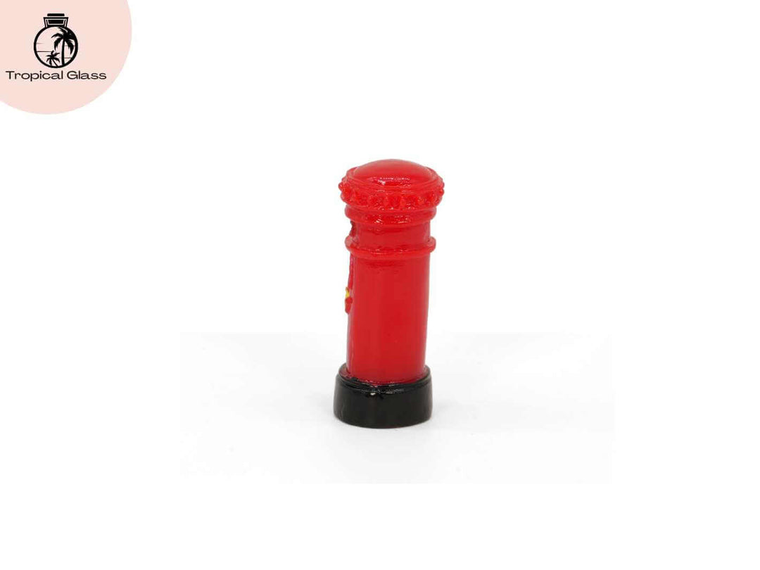 Side view of mini red British post box figurine showing shape and design details