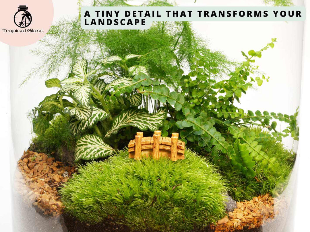 Miniature bridge figurine in a fairy garden style display with moss and gravel
