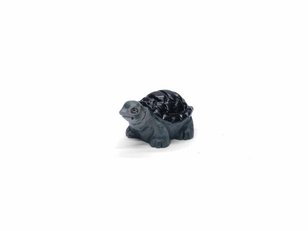 Tiny tortoise ornament for terrariums, with detailed shell and lifelike features.