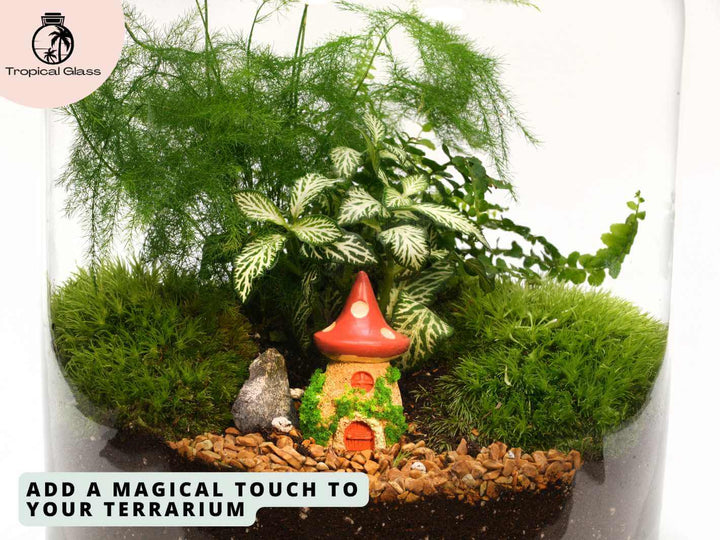Mini mushroom house figurine in a fairy garden style setup with moss and gravel