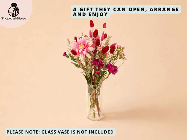 Red dried and artificial flower stems arranged in a glass vase after opening the letterbox gift box