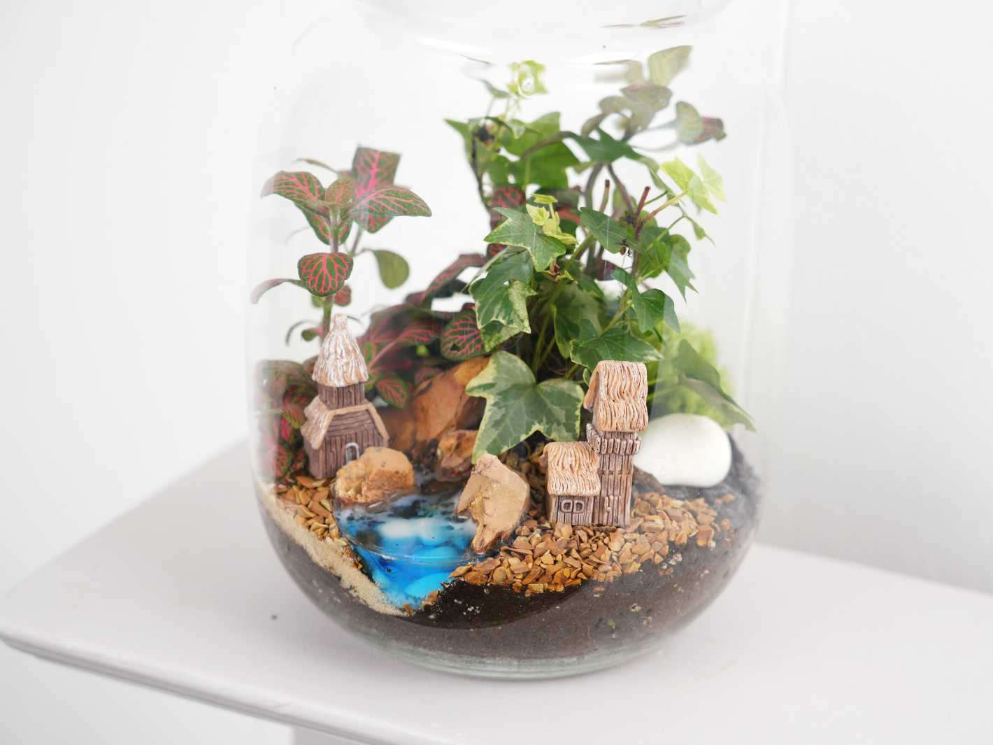 Close-up of a decorative house for terrariums, available in four unique styles.