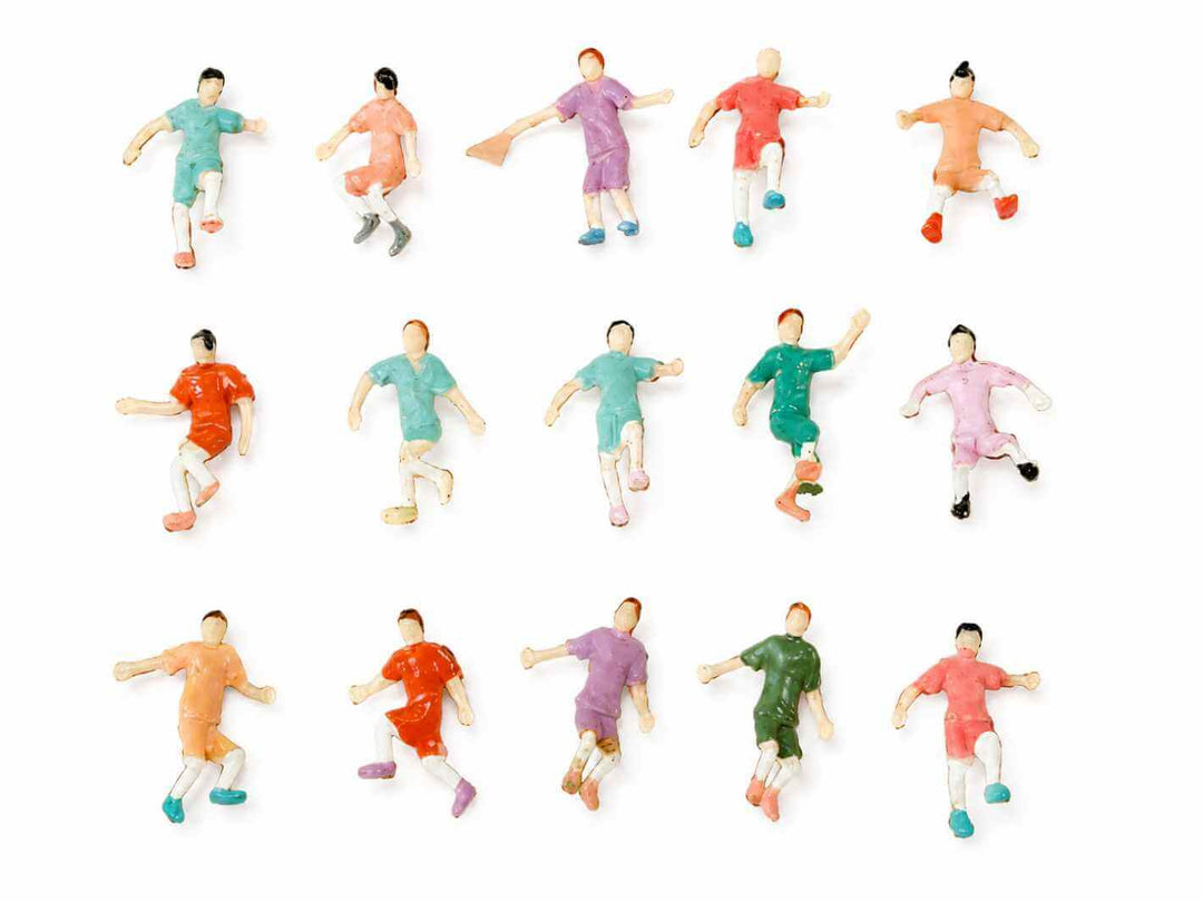 Set of 12 soccer player figurines in various colored uniforms on a white background
