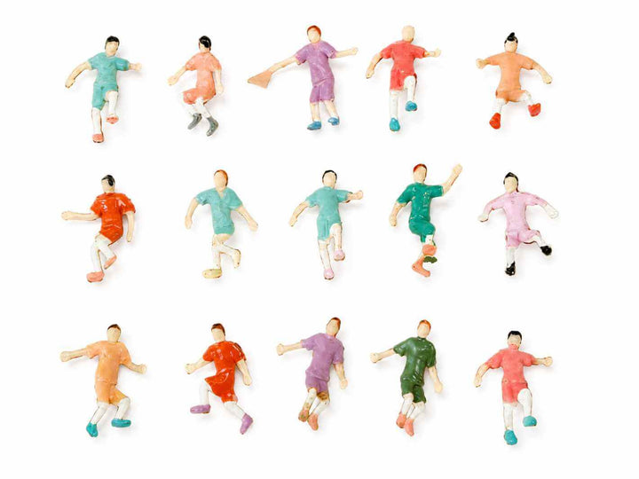 Set of 12 soccer player figurines in various colored uniforms on a white background