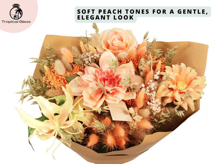 A beautiful bouquet featuring soft peach-toned flowers, including roses and daisies, combined with dried foliage and delicate textures. The arrangement is elegantly packaged in brown paper, showcasing a gentle and sophisticated look.