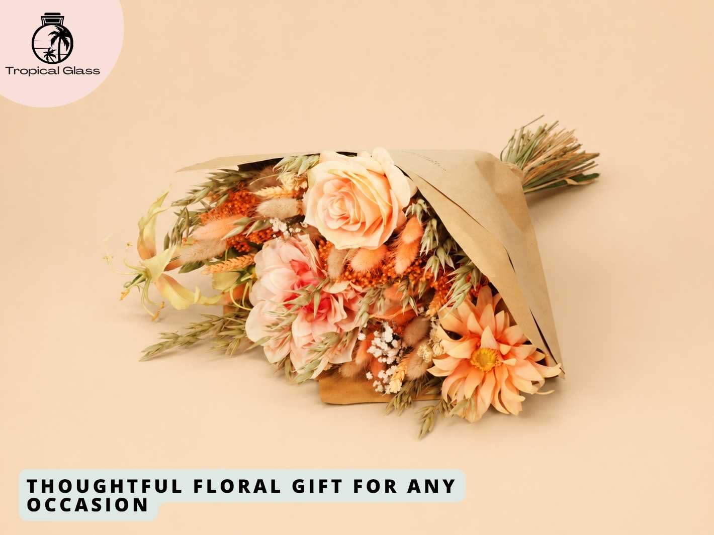 A beautifully arranged bouquet featuring soft peach and warm-toned flowers, including roses and dried elements, wrapped in natural brown paper. This elegant floral gift is perfect for any occasion and adds a touch of charm to any setting.