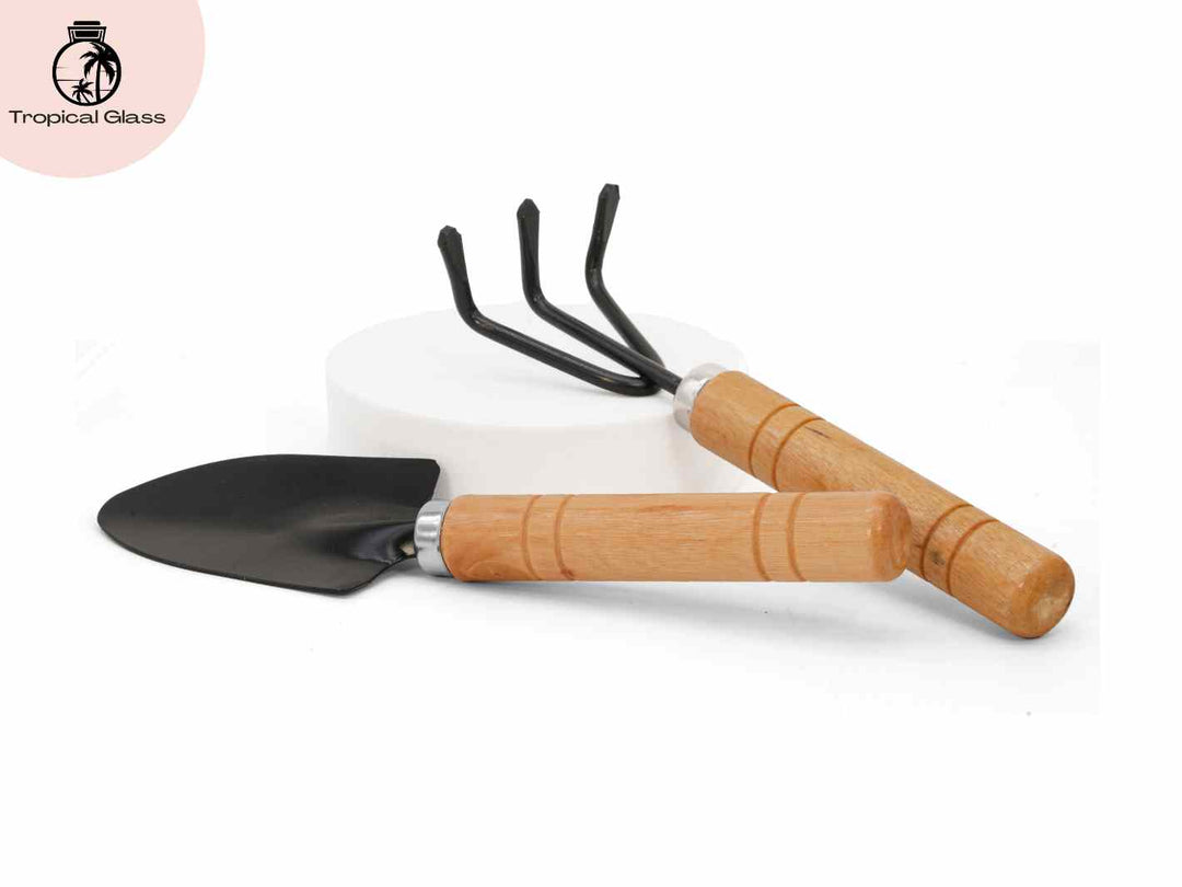 Mini terrarium shovel and rake set with wooden handles for planting and styling glass terrariums.