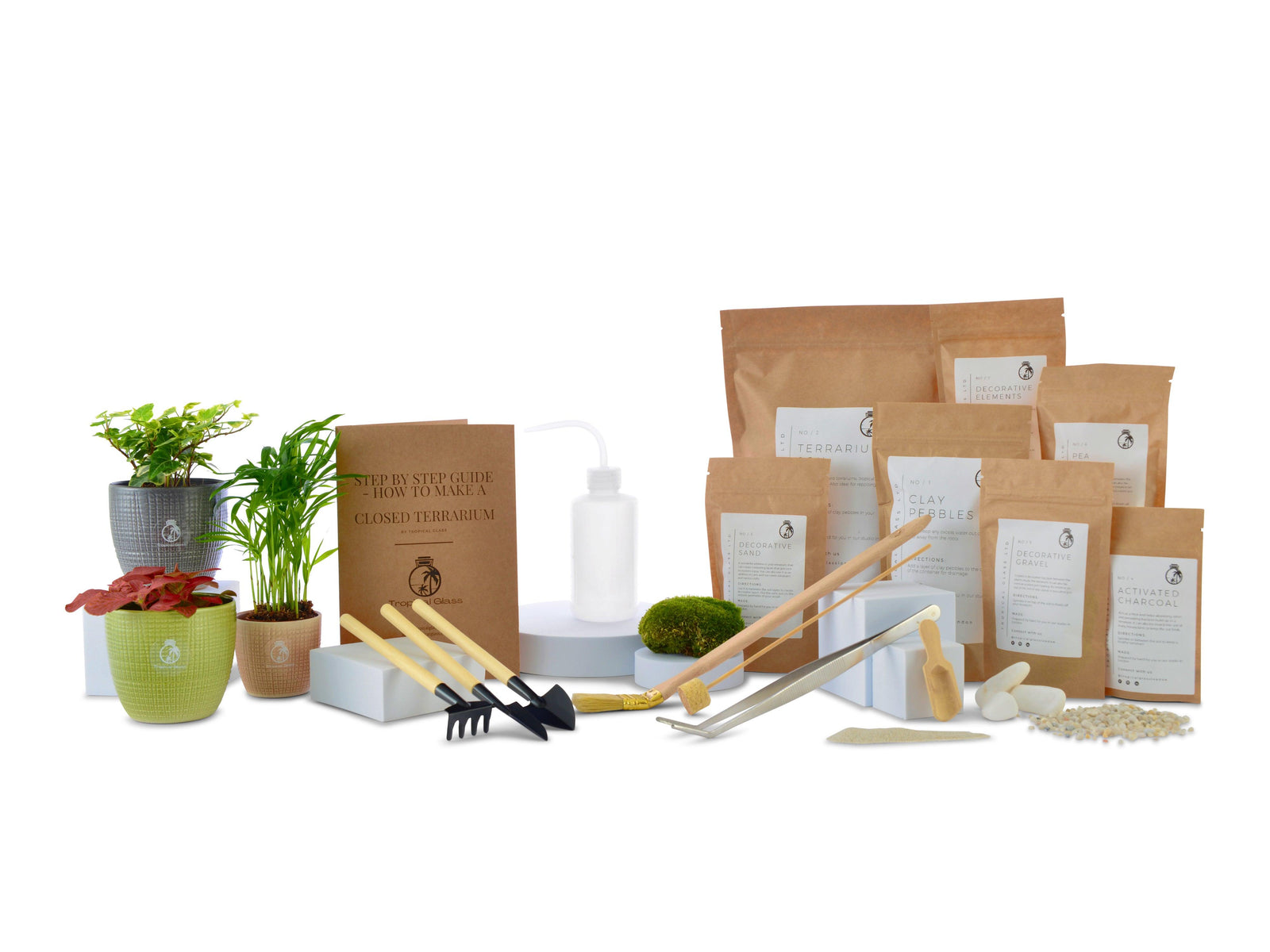 A medium DIY terrarium starter kit is displayed, featuring various plant pots, gardening tools, and multiple packets of terrarium materials.